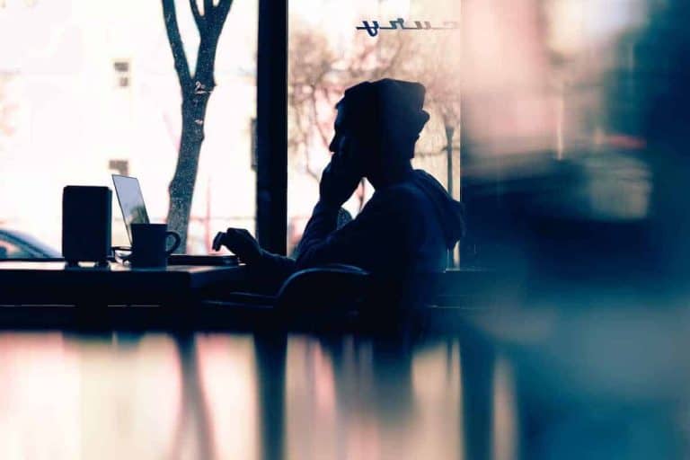 A person sitting at a table with a laptop.